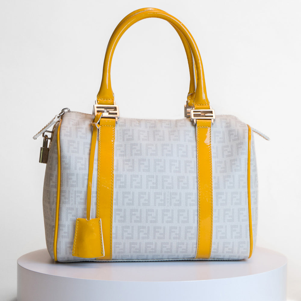 A designer handbag photographed in detail at Current Boutique