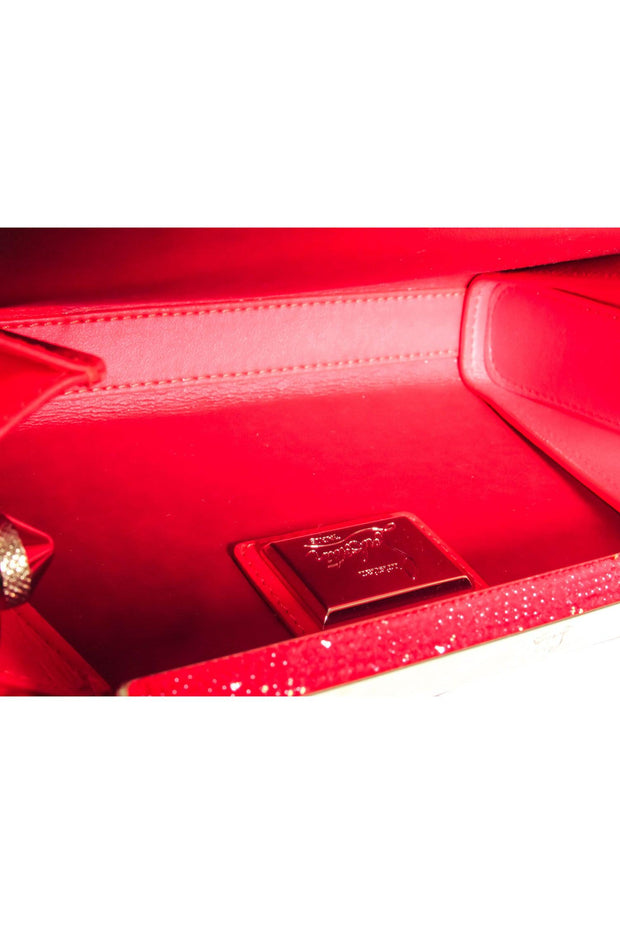 Current Boutique-Christian Louboutin - Gold & Black Print Clutch w/ Red Jewel Detail